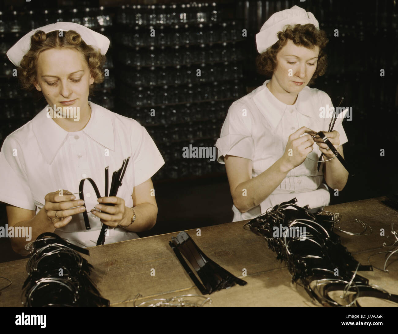 Women assemble bands for blood transfusion bottles, 1942. Stock Photo