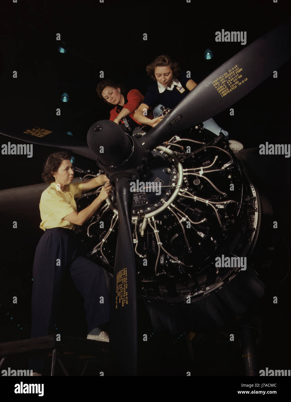 The careful hands of women are trained in precise aircraft engine installation, 1942. Stock Photo