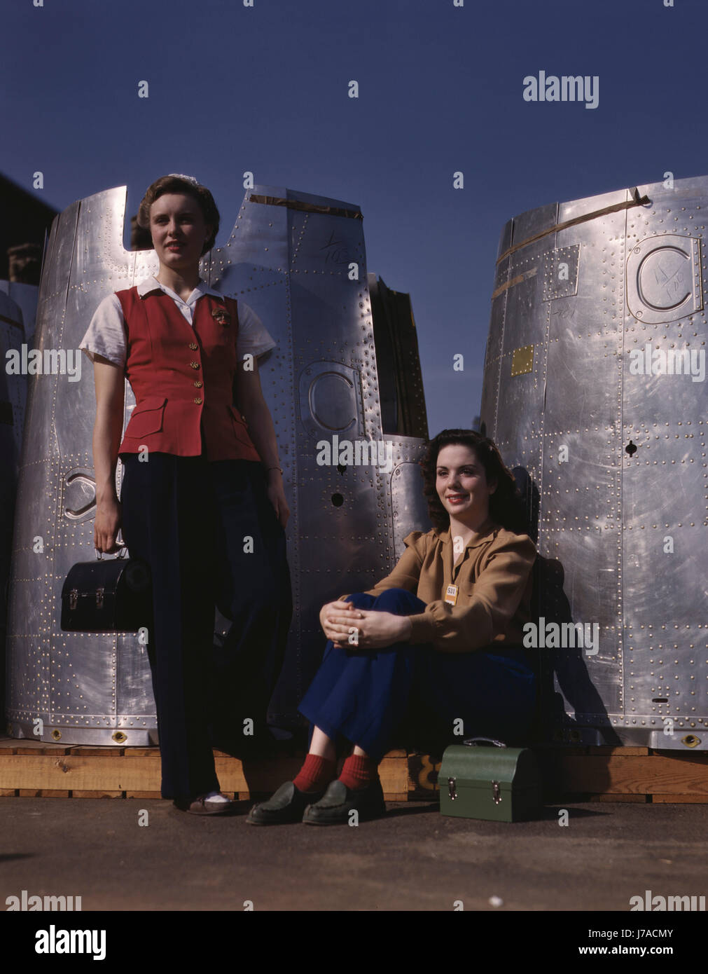 Two female assembly line workers enjoy a lunch break at Douglas Aircraft Company, 1942. Stock Photo