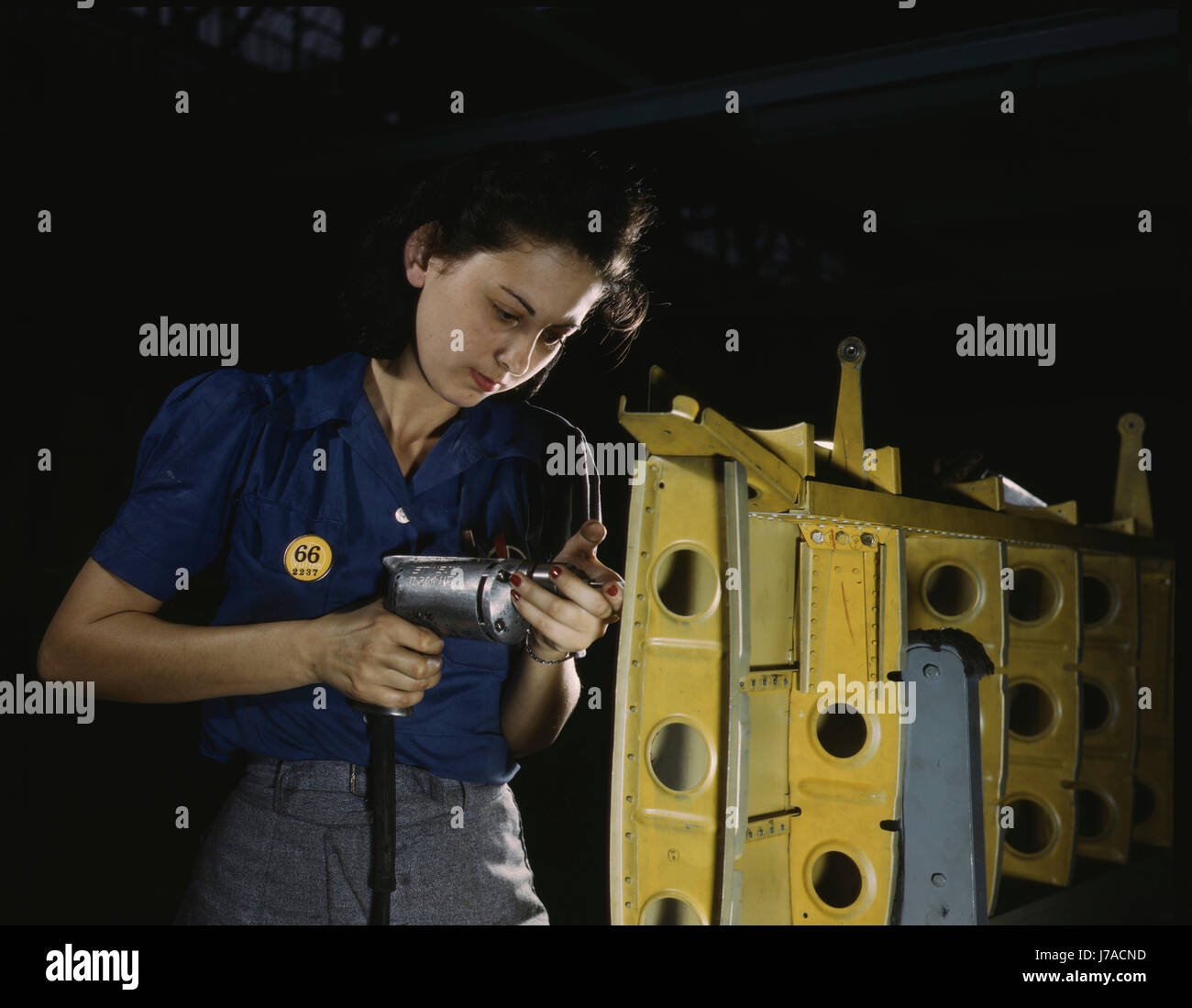 Woman drilling horizontal stabilizers on an A-31 Vengeance bomber plane, 1943. Stock Photo