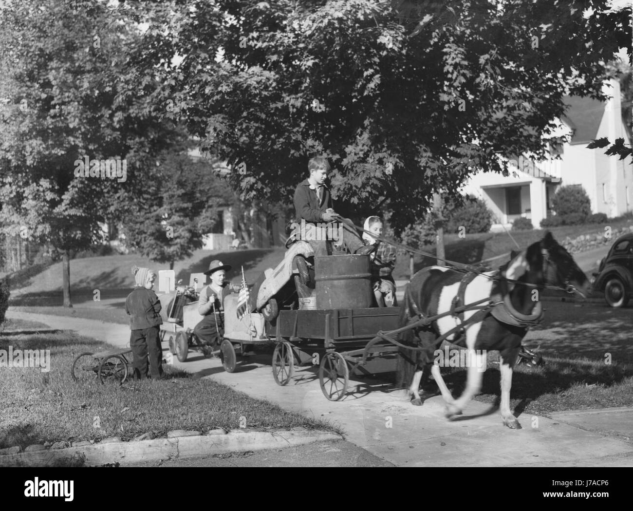 Youngsters collecting scrap on a pony cart for donation to their war industries, 1942. Stock Photo