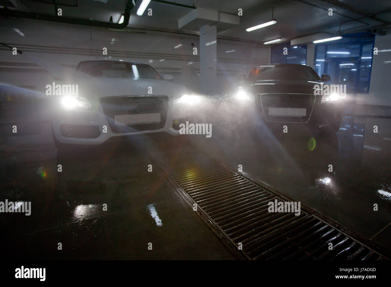Cars with headlight in car wash Stock Photo