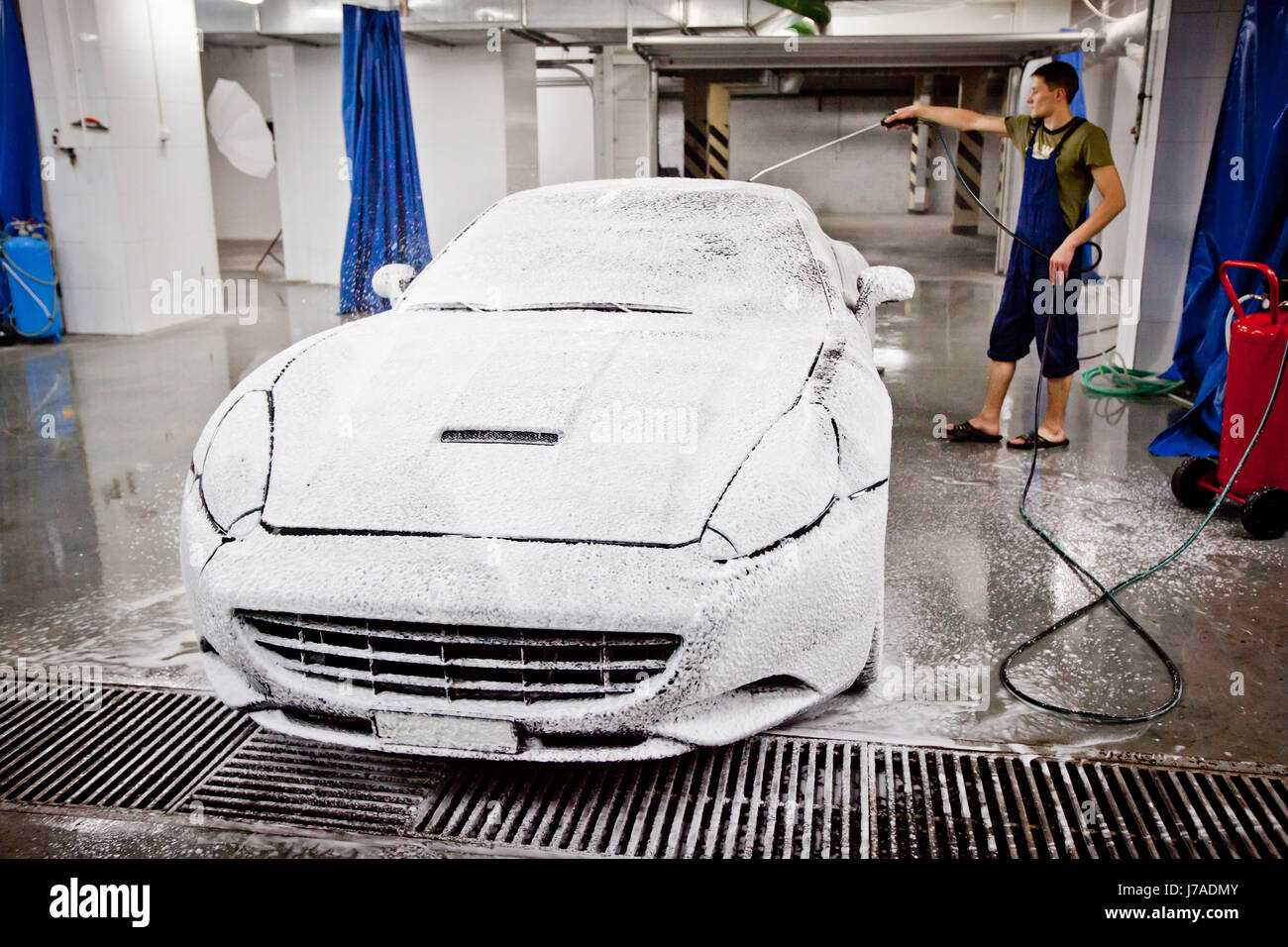 Person cleaning vehicle in car wash Stock Photo Alamy