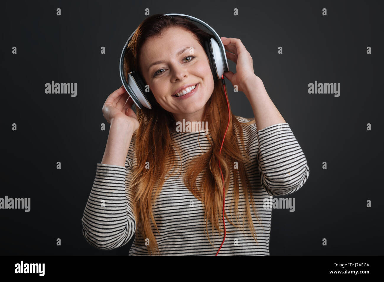 Charmed smiling girl listening to music Stock Photo