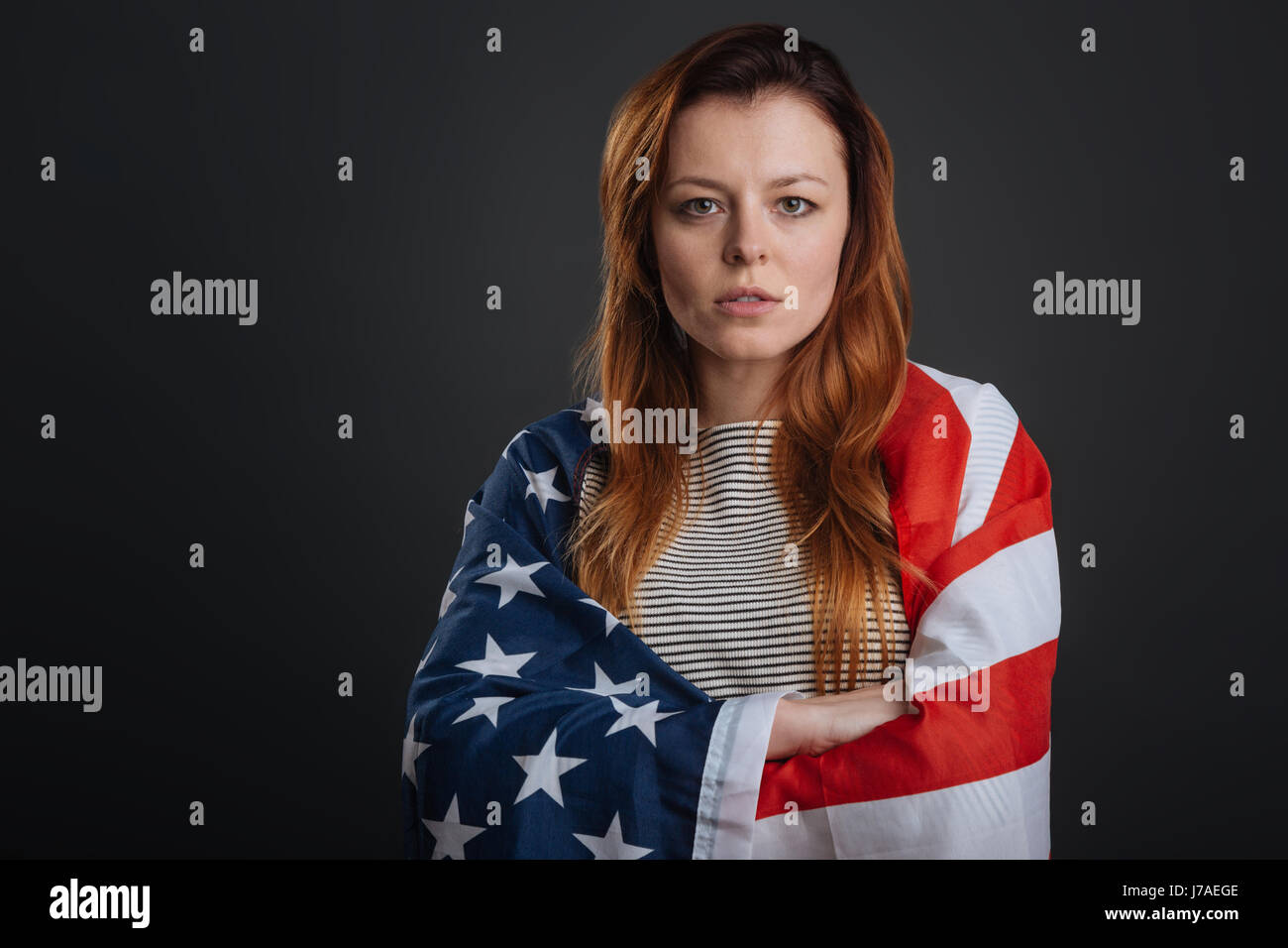 Committed young woman working on patriotic photoshoot Stock Photo