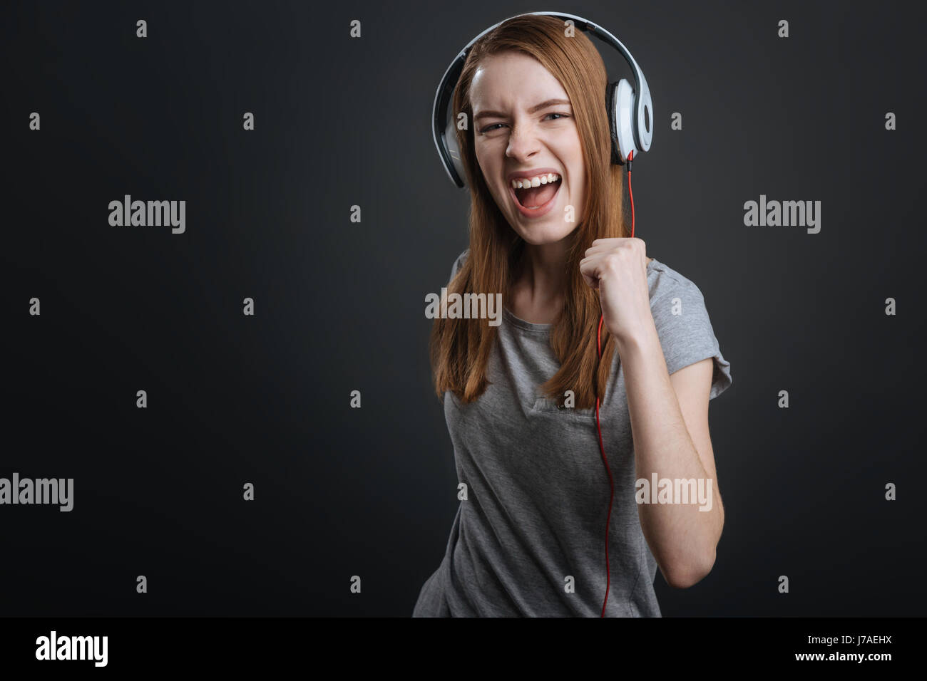 Energetic pretty girl wearing new headphones Stock Photo
