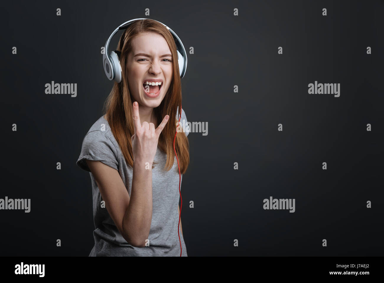 Expressive hilarious girl rocking new headphones Stock Photo
