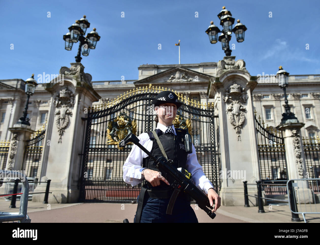 An armed police officer outside Buckingham Palace, London, as the