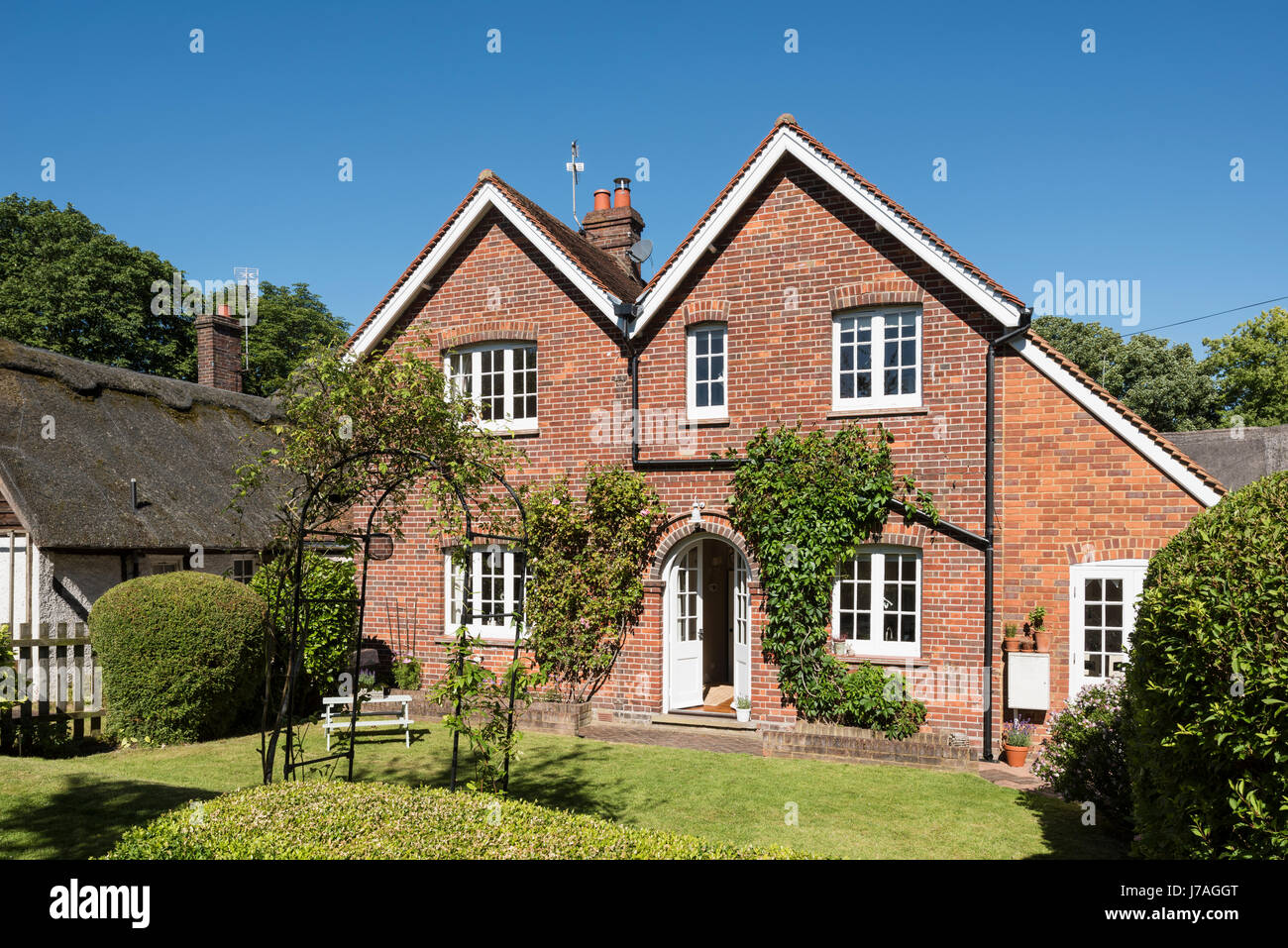 External rear facade of idyllic Grade II brick cottage Stock Photo