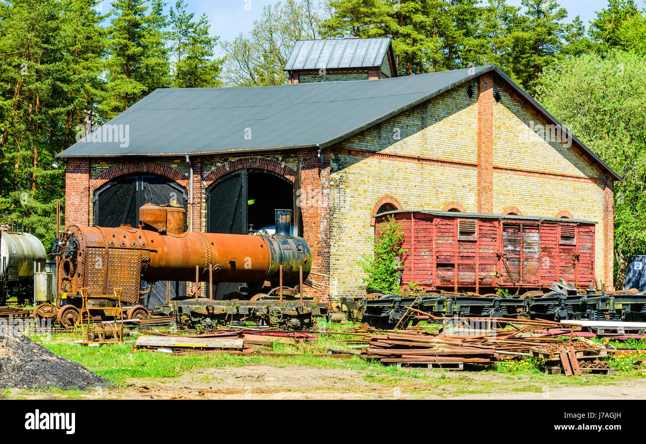 Brosarp, Sweden - May 18, 2017: Documentary of public historic railway station area. Very small roundhouse with lots of spare vintage cars and steam e Stock Photo
