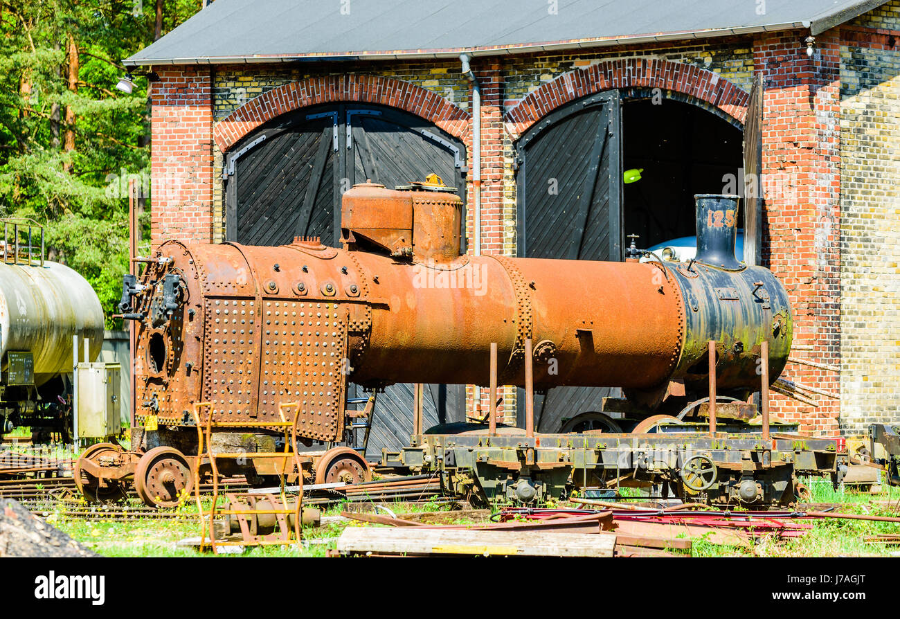 Brosarp, Sweden - May 18, 2017: Documentary of public historic railway station area. Rusty old water tank and furnace of steam locomotive standing out Stock Photo