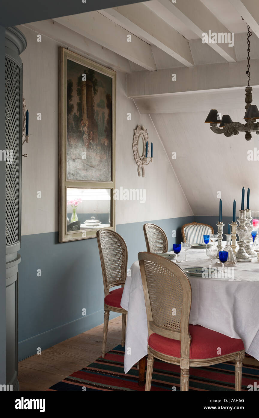 Silverware candlesticks on dining table with corner with 18th
