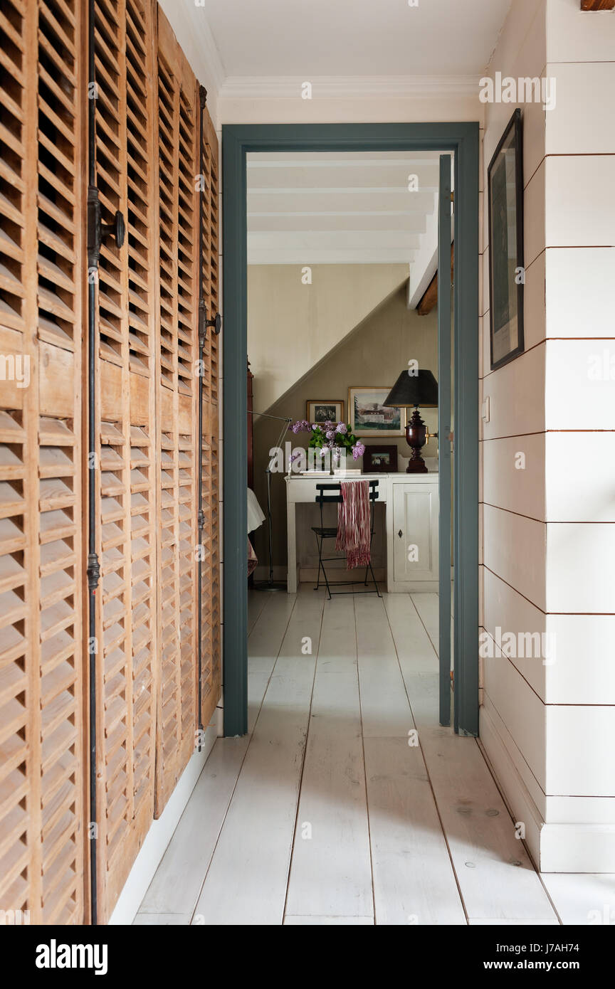 Louvered wooden storage cupboards provide generous space Stock Photo
