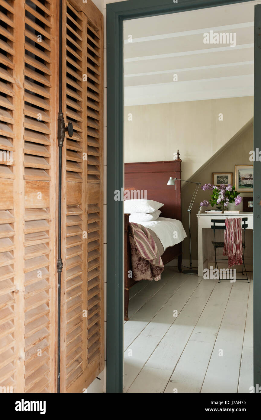 Louvered wooden storage cupboards provide generous space Stock Photo