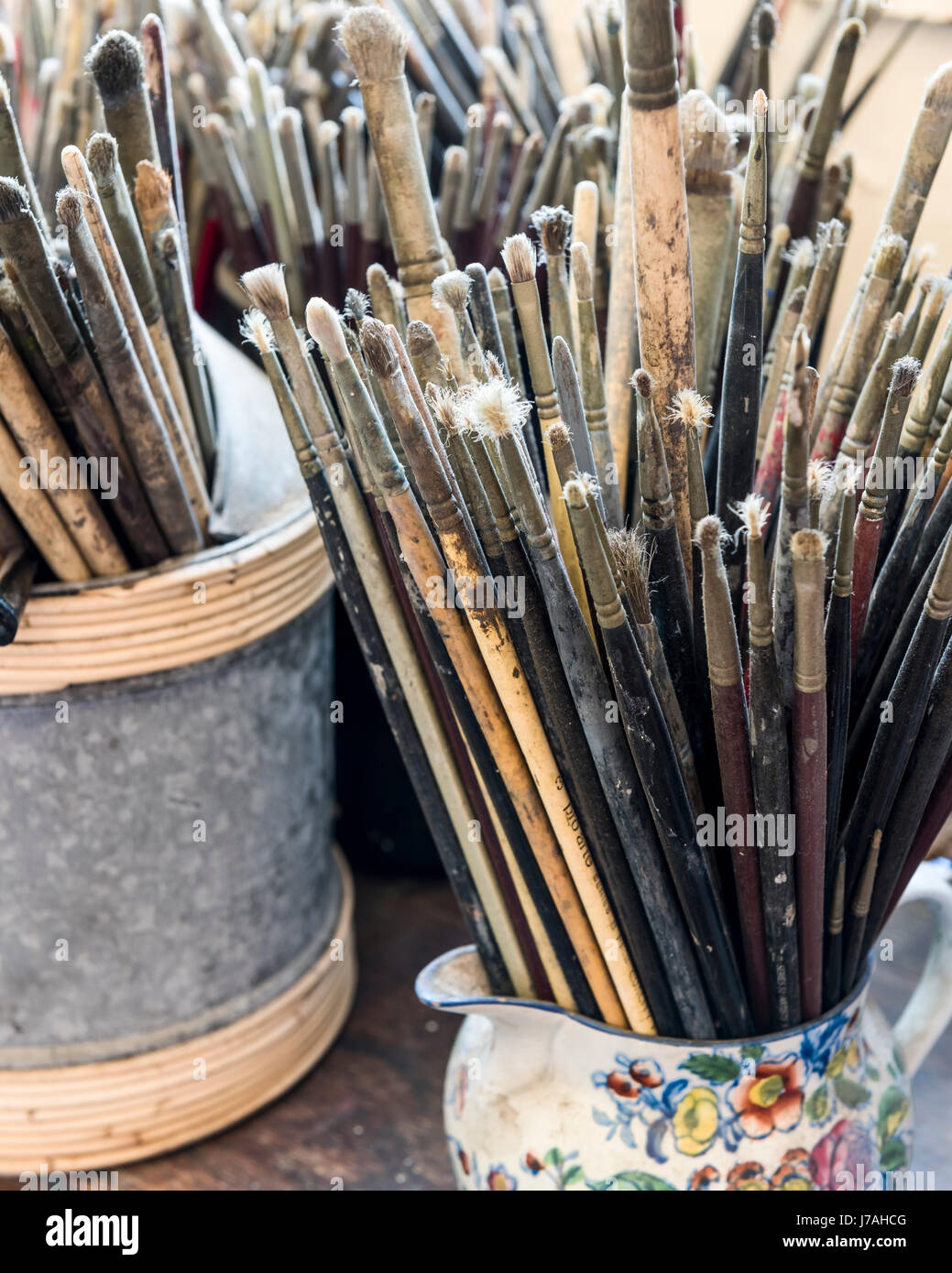 Artists paint brushes stored in jars Stock Photo