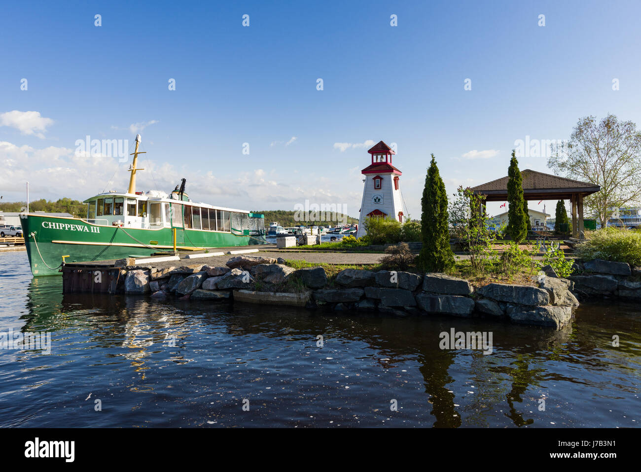 Parry Sound Harbour With Small Lighthouse and boat in water Stock Photo