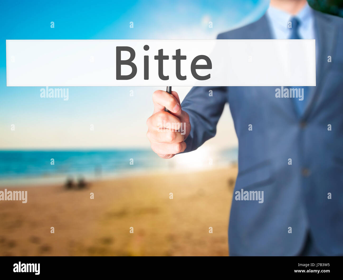 Bitte (Please in German) - Businessman hand holding sign. Business ...