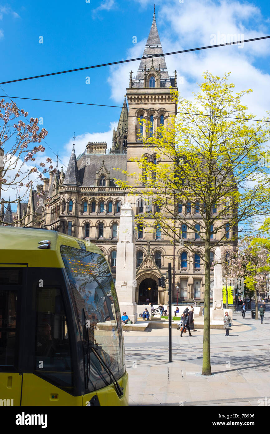 War memorial outside the rear entrance of Town Hall with passing tram on St Peter's Square in Manchester UK Stock Photo
