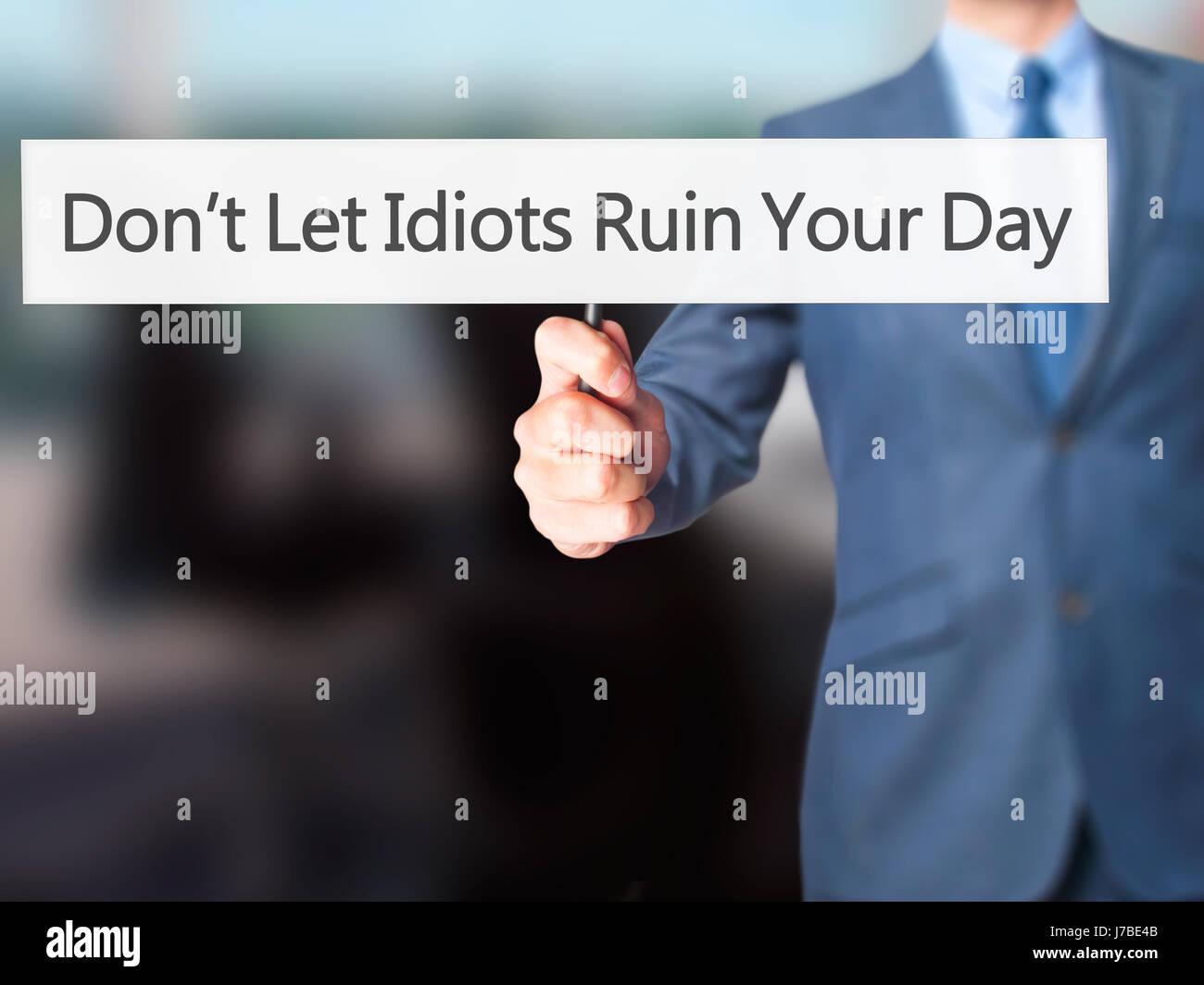 Don't Let Idiots Ruin Your Day - Businessman hand holding sign ...
