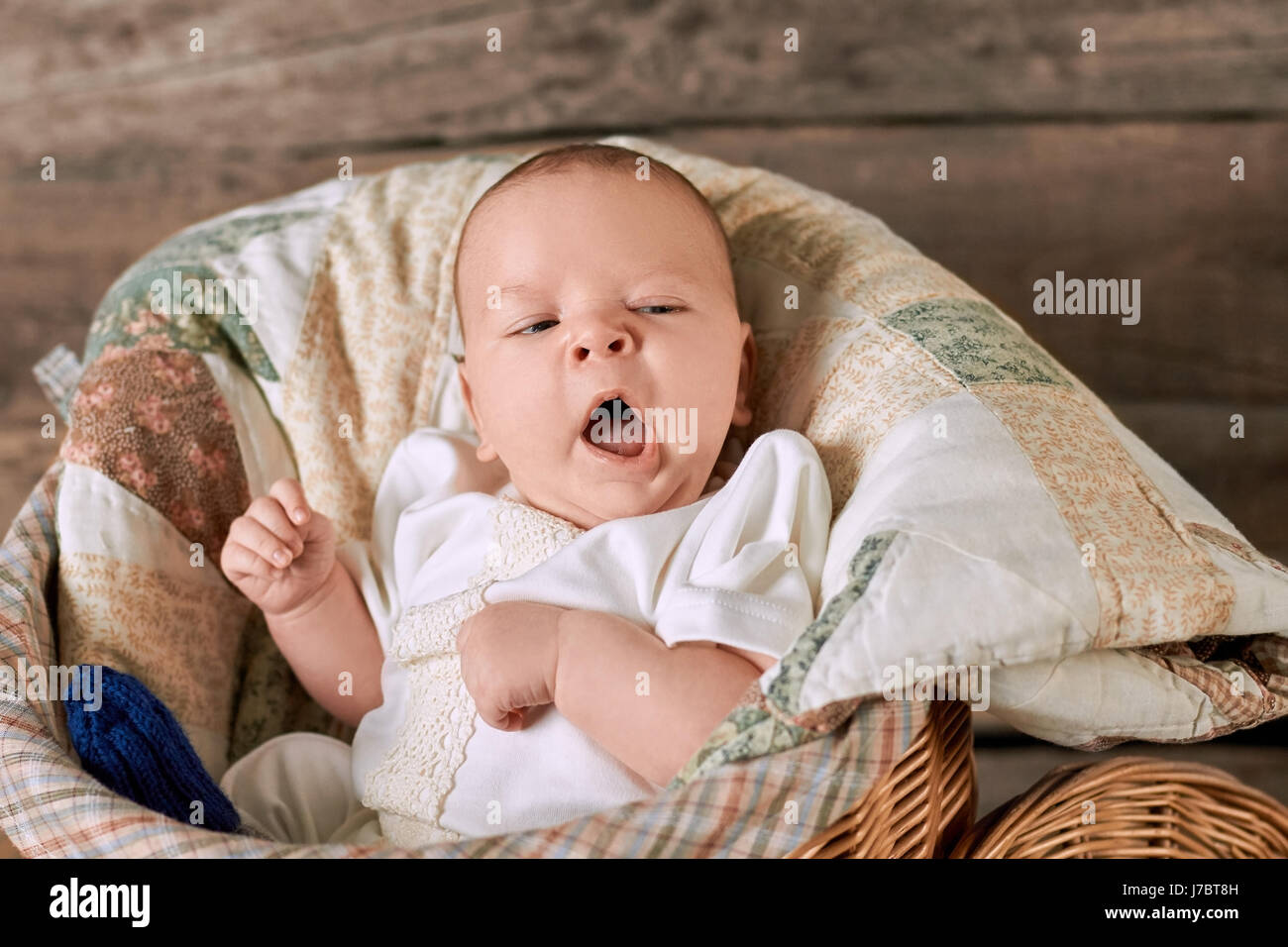 Baby is yawning. Infant with mouth open. Tiredness and boredom. Stock Photo