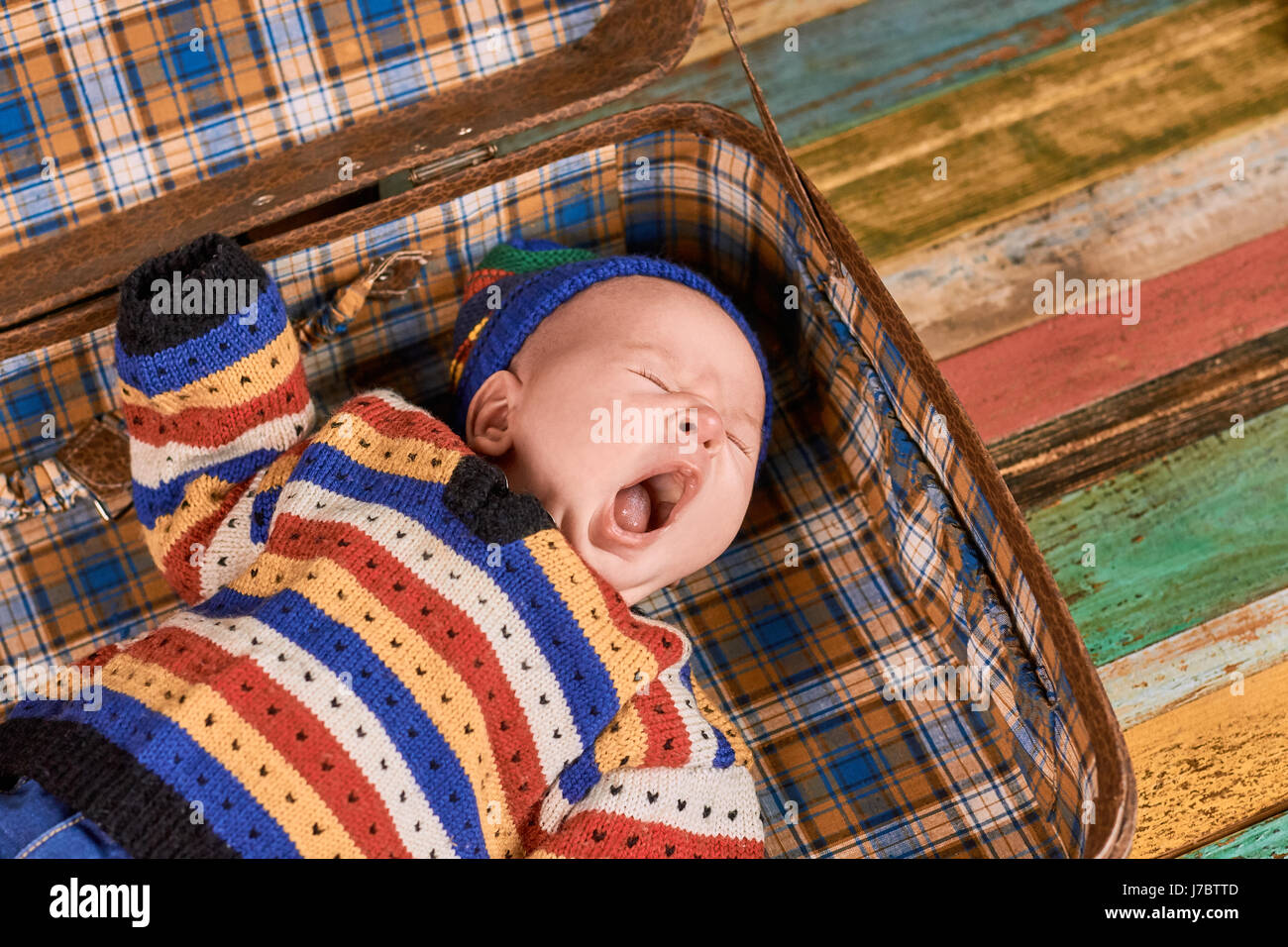 Cute baby yawning. Child lying with mouth open. Stock Photo