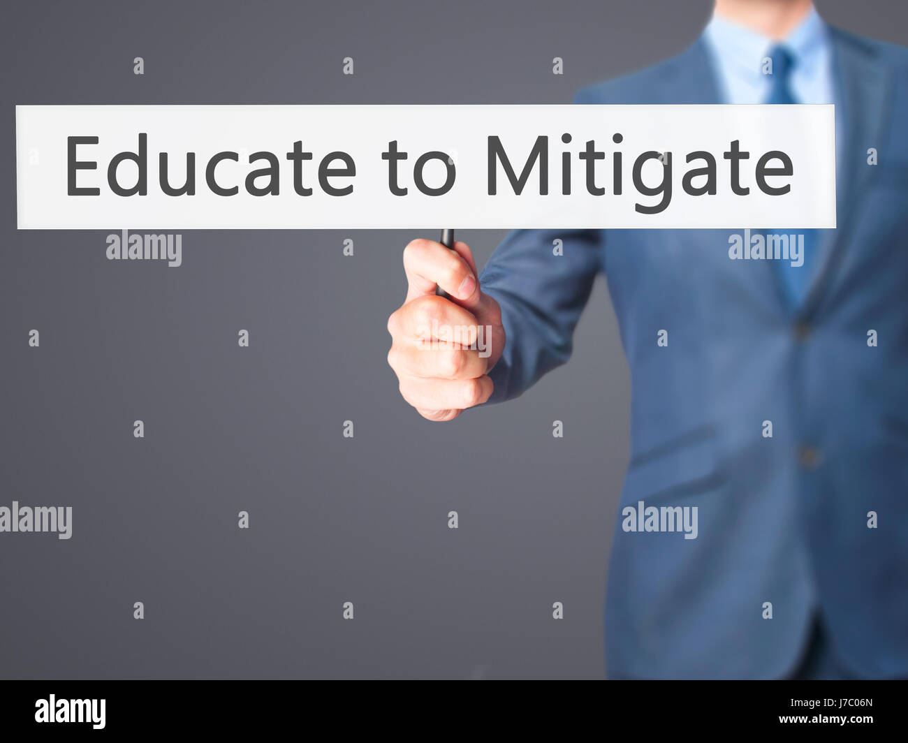 Educate to Mitigate - Businessman hand holding sign. Business ...