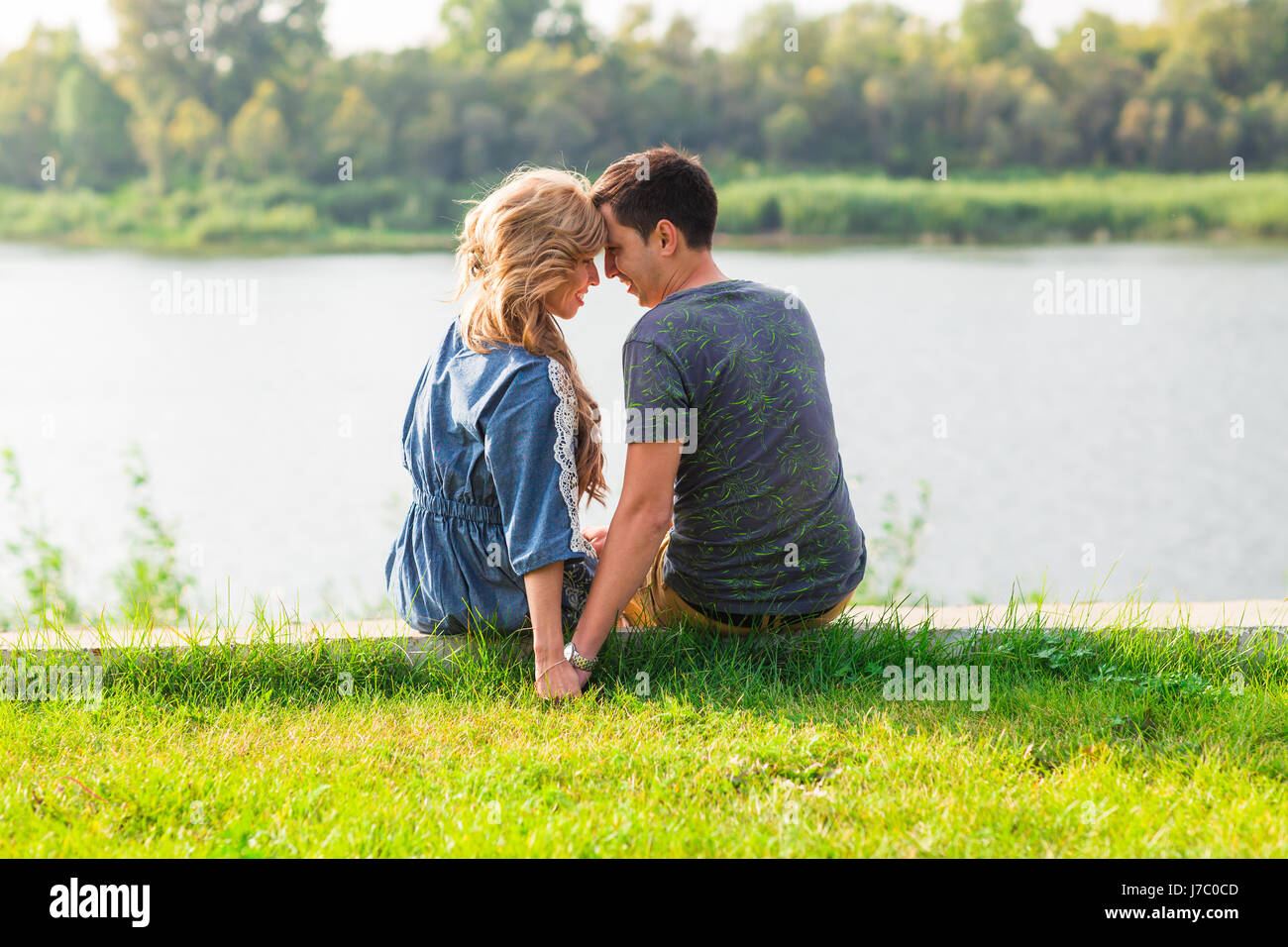 beautiful love young couple on the pier near the river Stock Photo - Alamy