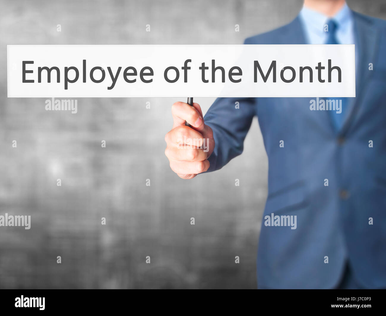 Employee of the Month - Businessman hand holding sign. Business, technology, internet concept. Stock Photo Stock Photo