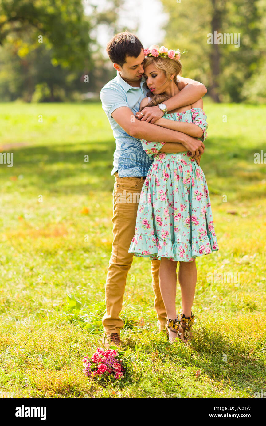 beautiful young couple hugging in the park Stock Photo - Alamy