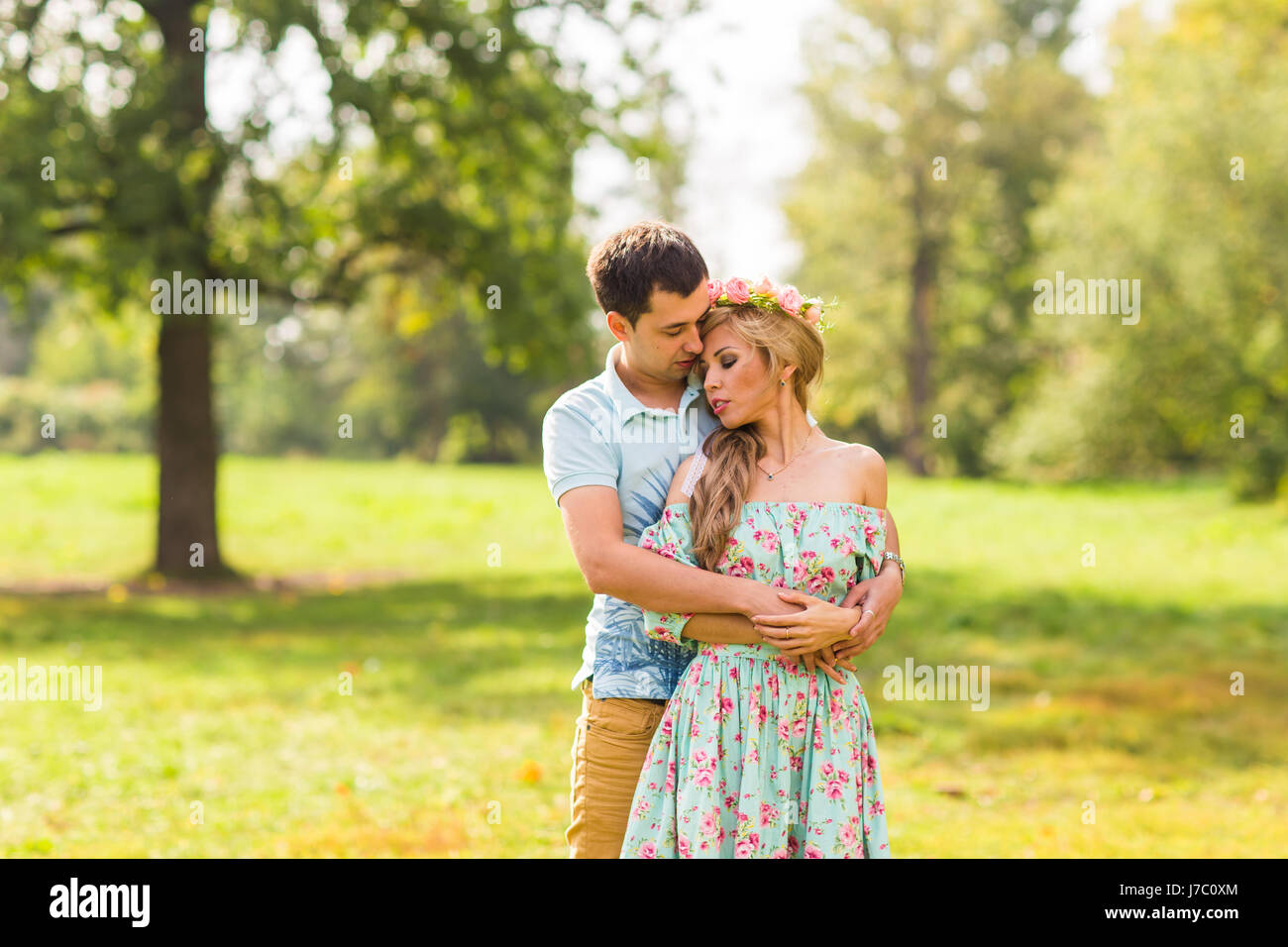 beautiful young couple hugging in the park Stock Photo - Alamy