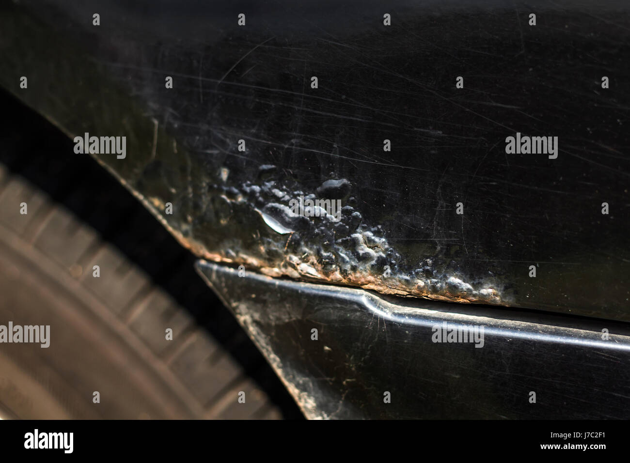 Rust focus on the black car fender Stock Photo Alamy