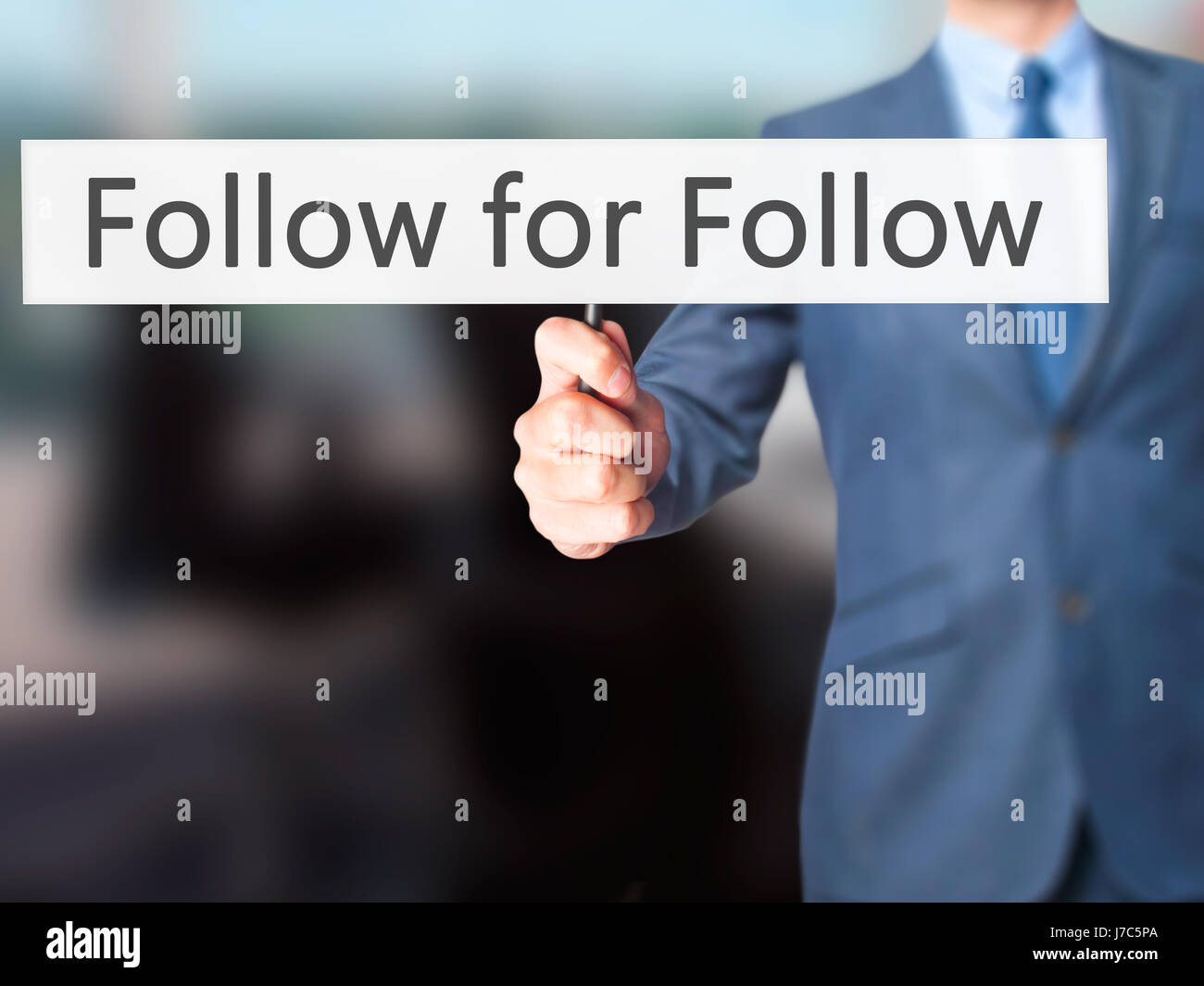 Follow for Follow - Businessman hand holding sign. Business, technology ...