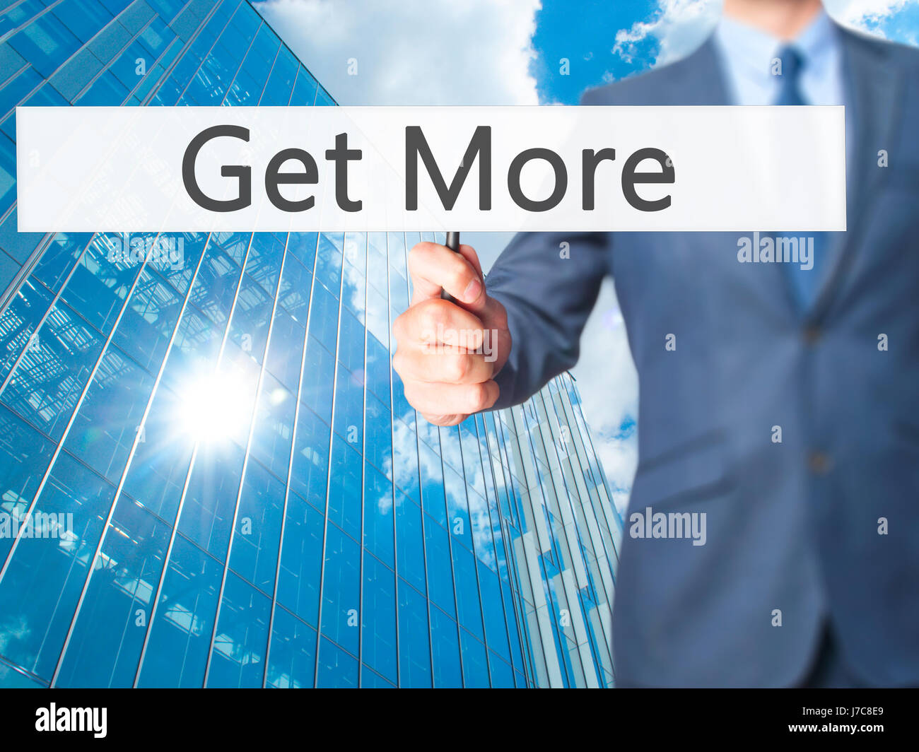 Get More - Businessman hand holding sign. Business, technology ...