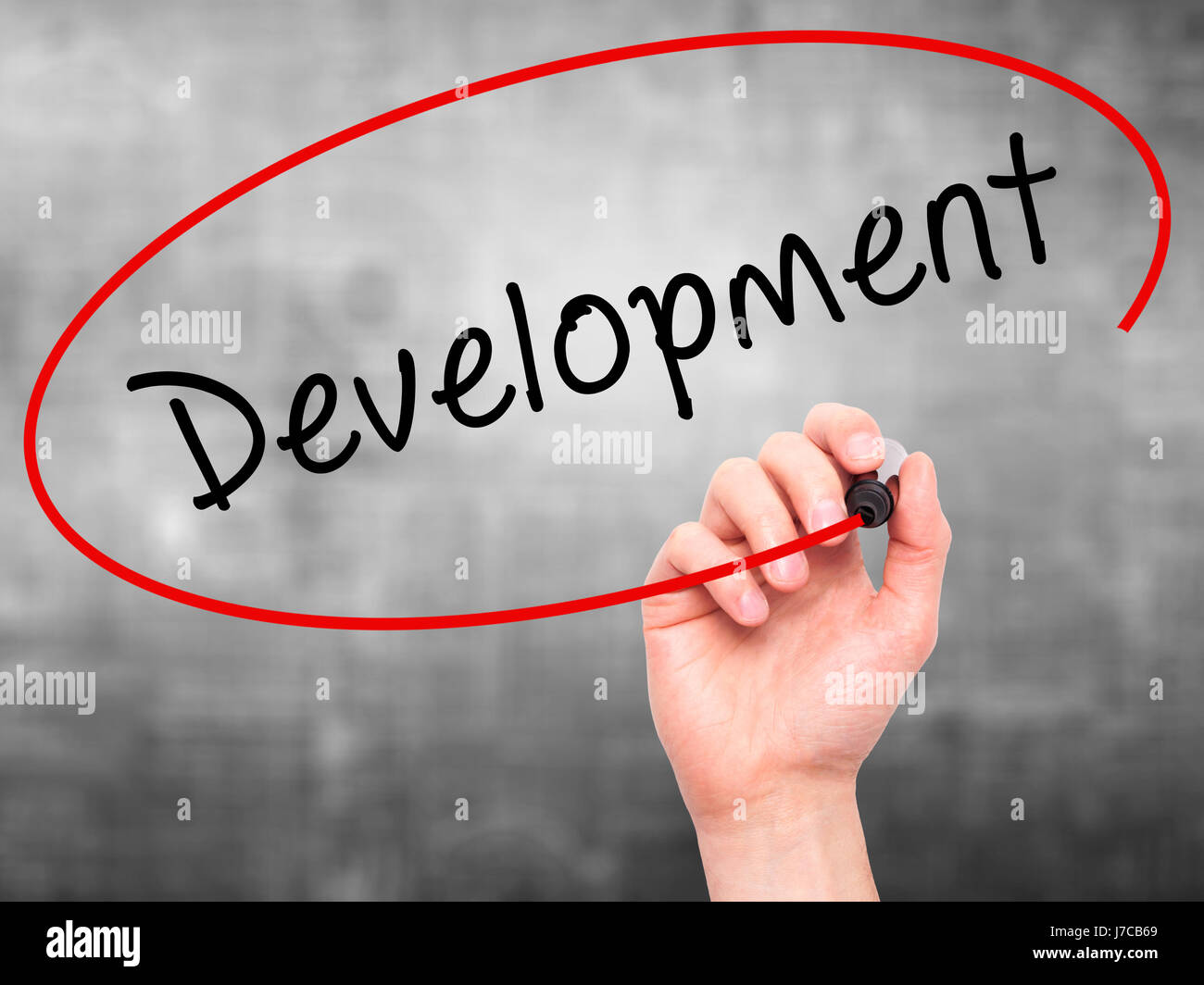 Man Hand writing Development with black marker on visual screen ...