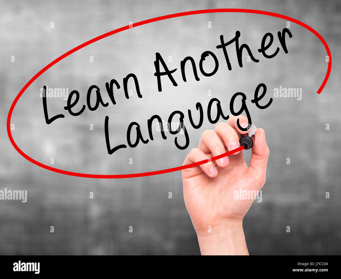 Man Hand writing Learn Another Language with black marker on visual ...
