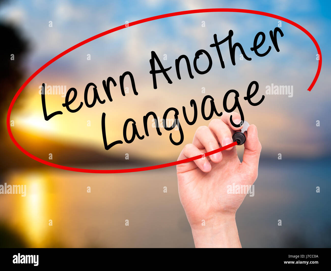 Man Hand writing Learn Another Language with black marker on visual ...