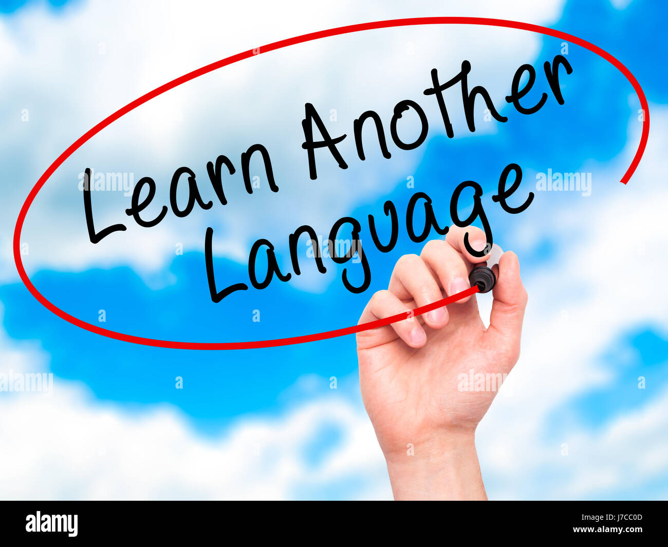 Man Hand writing Learn Another Language with black marker on visual ...