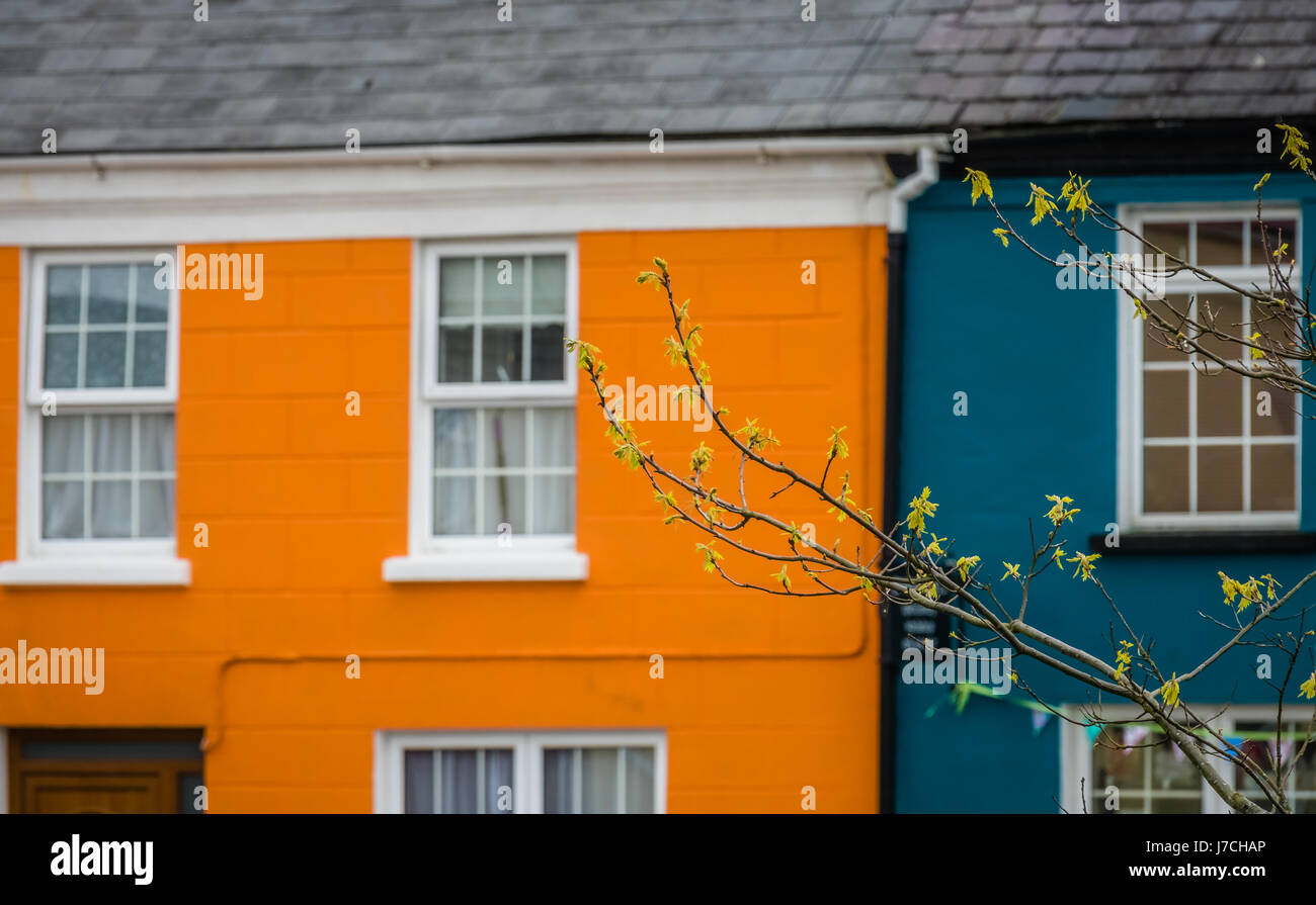 Orange and blue home facades in a small picturesque irish town Sneem on the Ring of Kerry route, Ireland Stock Photo