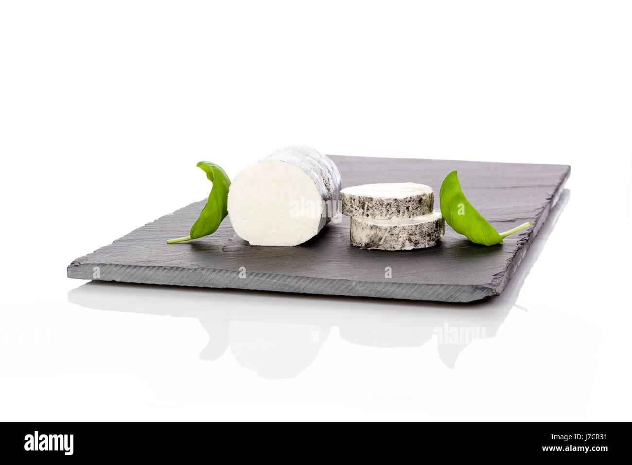 Goat cheese on minimalistic plate isolated on white background. Luxurios cheese eating. Stock Photo
