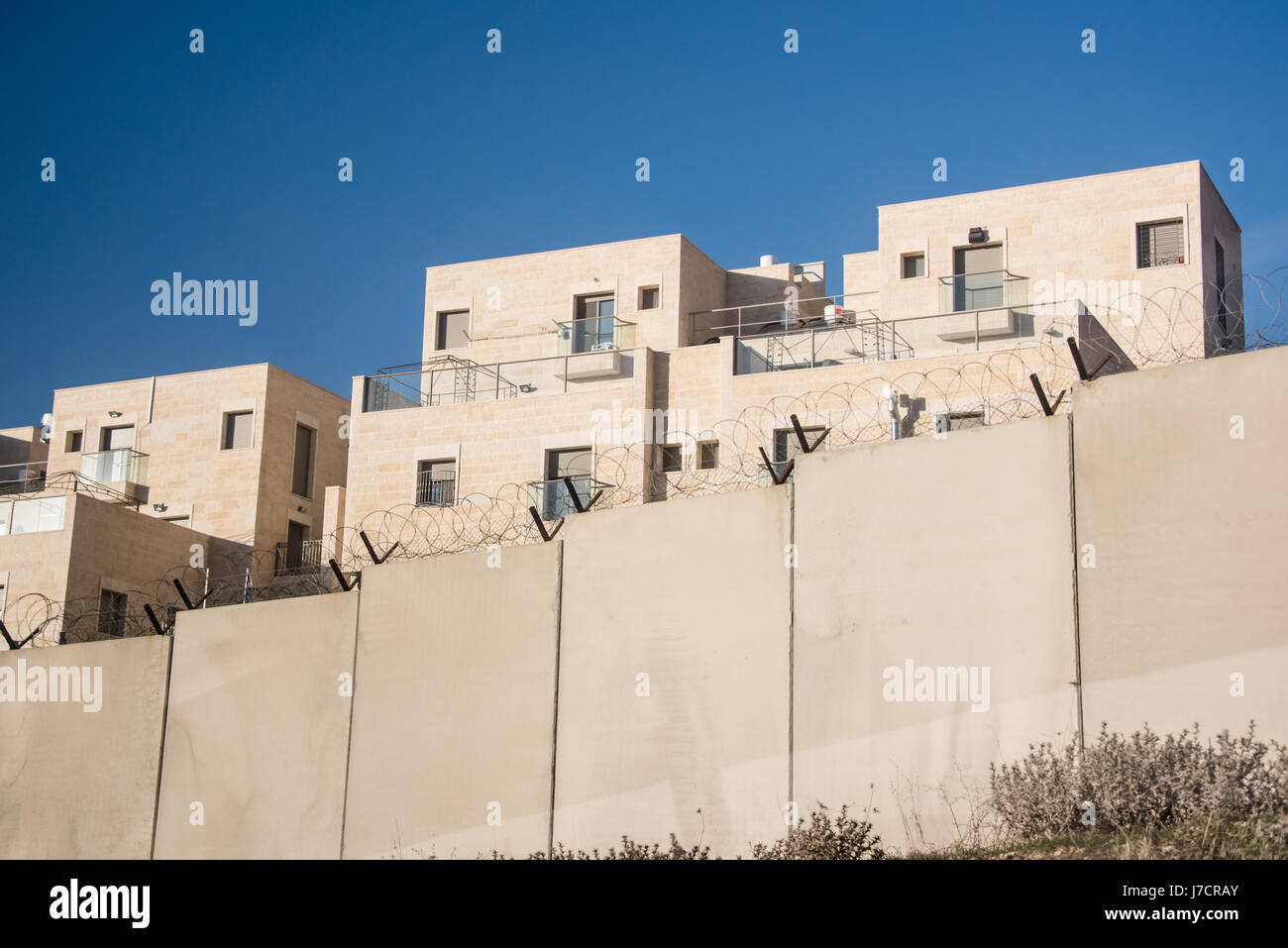 The Israeli Separation Wall encircles the settlement of Har Gilo on land belonging to the West Bank village of Al Walaja, December 30, 2016. Israel's wall and settlements have both been declared illegal according to international law. Stock Photo