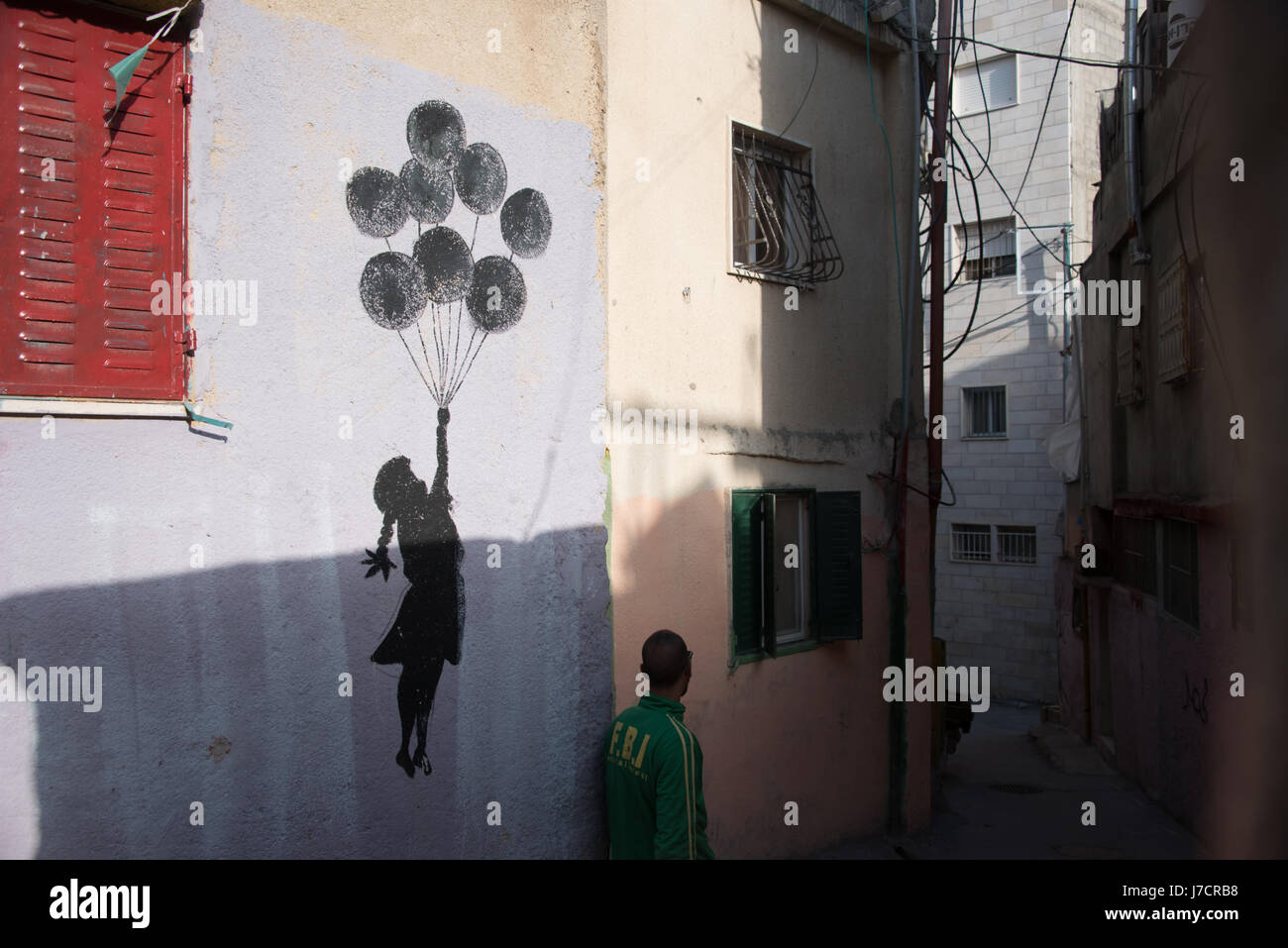An imitation of a Banksy mural decorates a wall in Aida Refugee Camp, West Bank, January 2, 2017. Stock Photo