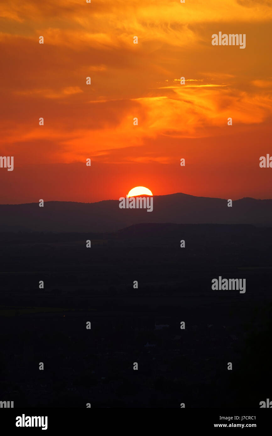 The setting sun from the Rising Sun Inn, Cleeve Hill Stock Photo