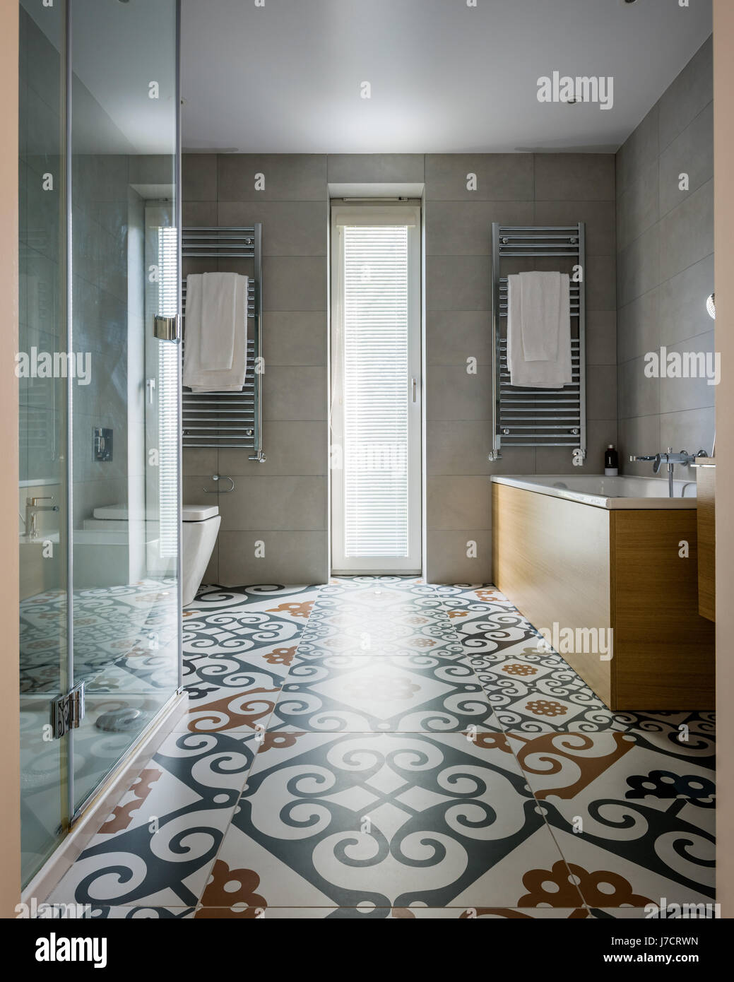 Wall mounted radiators and dramatic Majolica floor tiles in bathroom ...