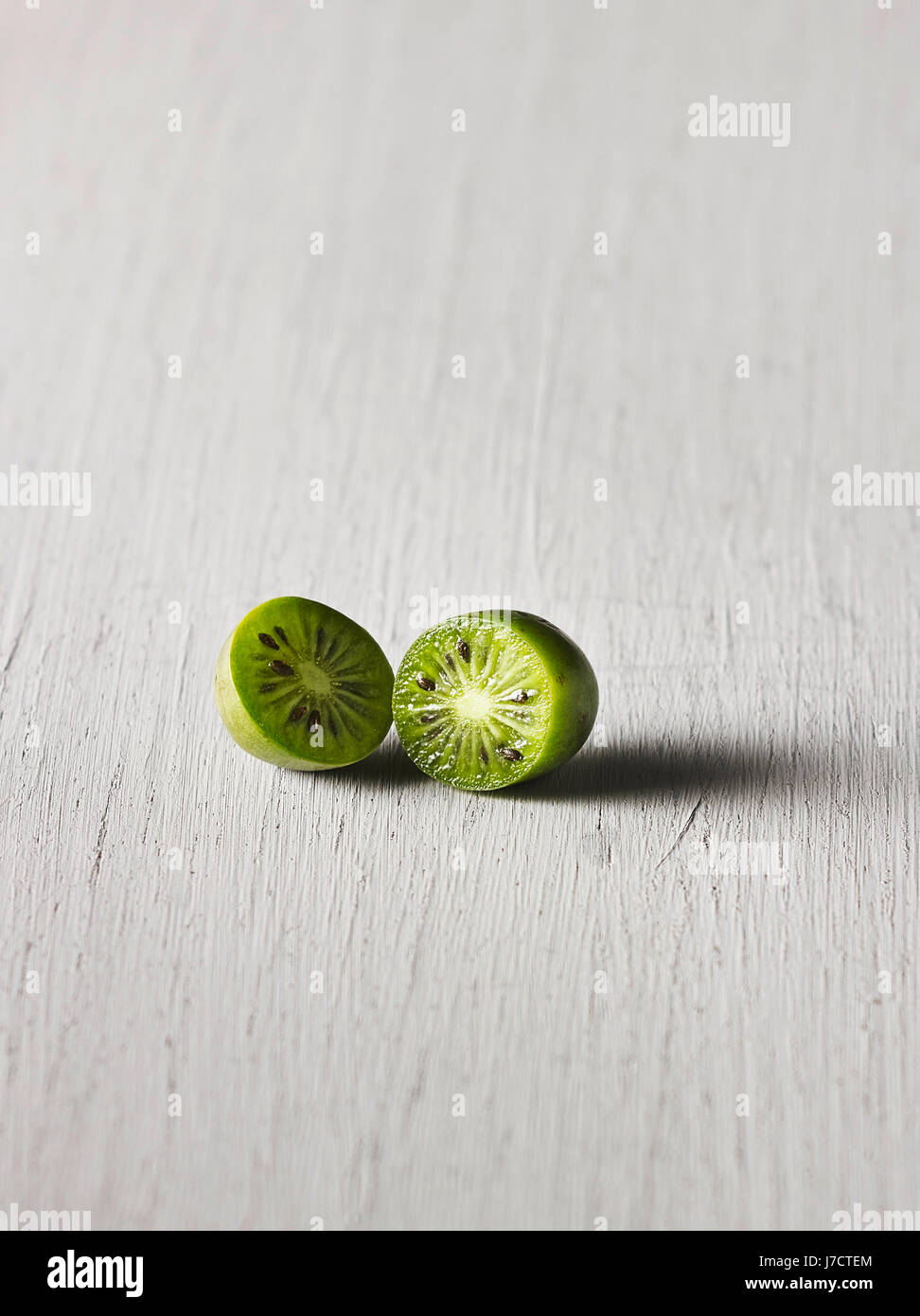 Still: Halfed nergi berry on wooden surface Stock Photo