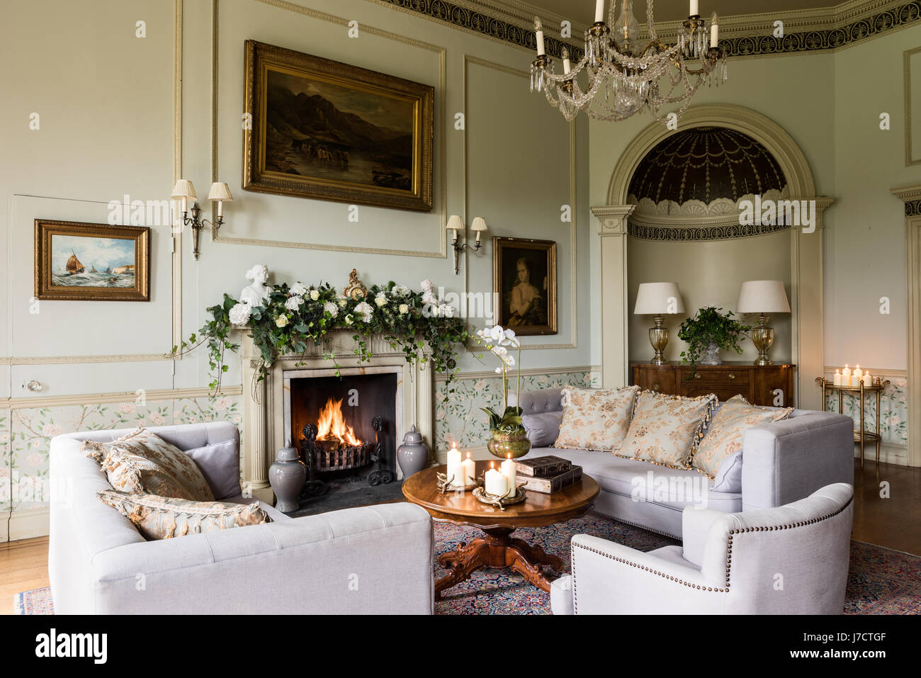 Stately drawing room with ivy christmas decoration on mantelpiece. Stock Photo