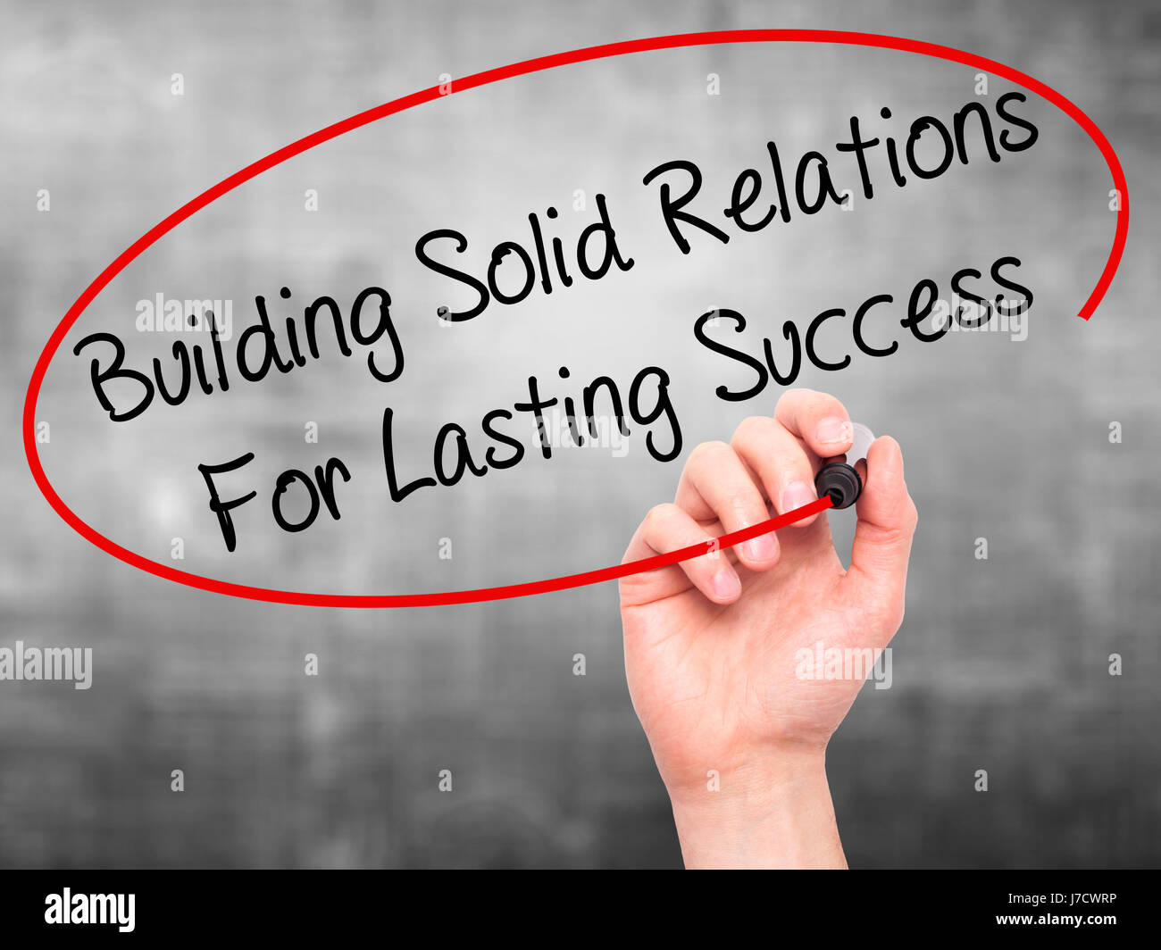 Man Hand writing Building Solid Relations For Lasting Success with ...