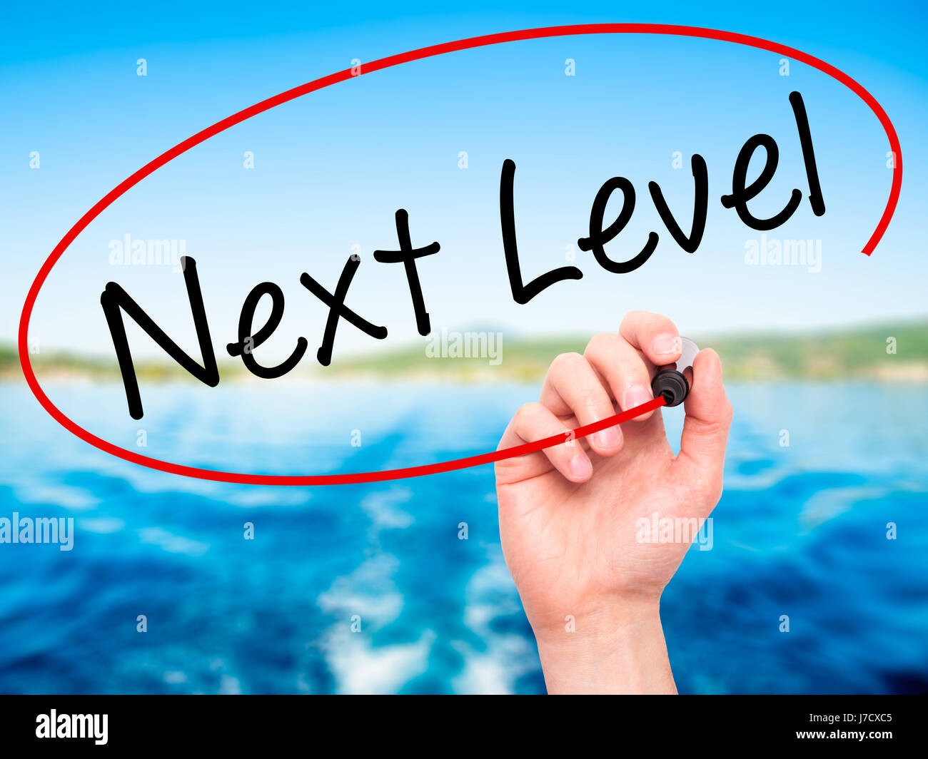 Next Level Screen Next Man Hand writing Next Level with black marker on visual screen ...