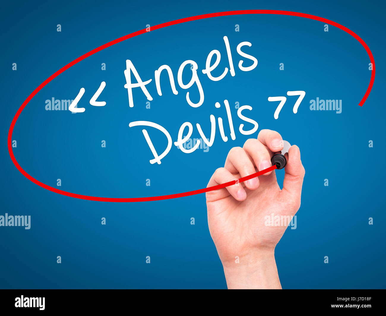 Man Hand writing Angels - Devils with black marker on visual screen ...