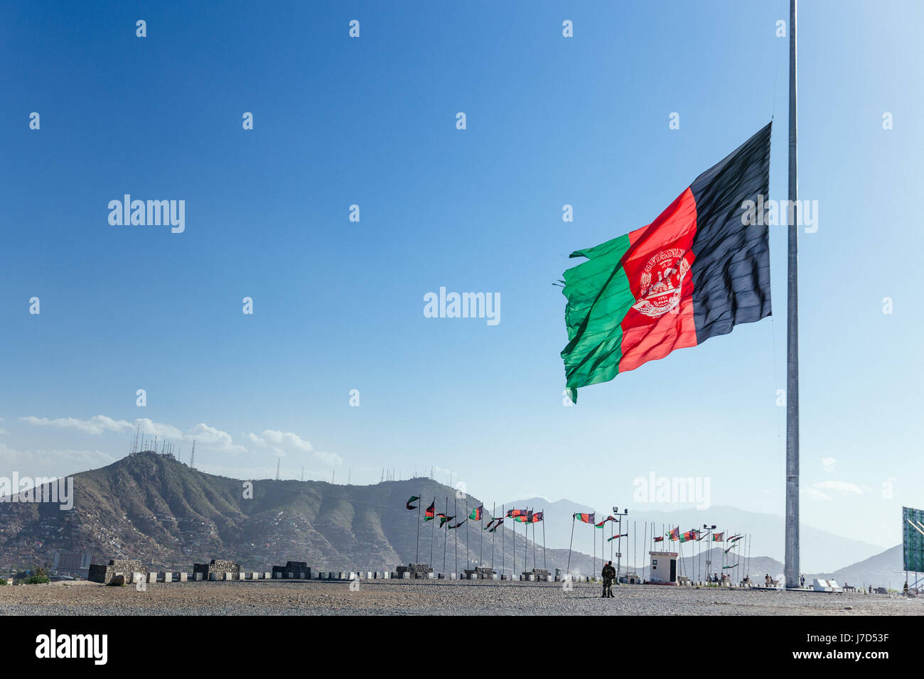 The flag of Afghanistan at half mast on Wazir Akbar Khan hill. Stock Photo