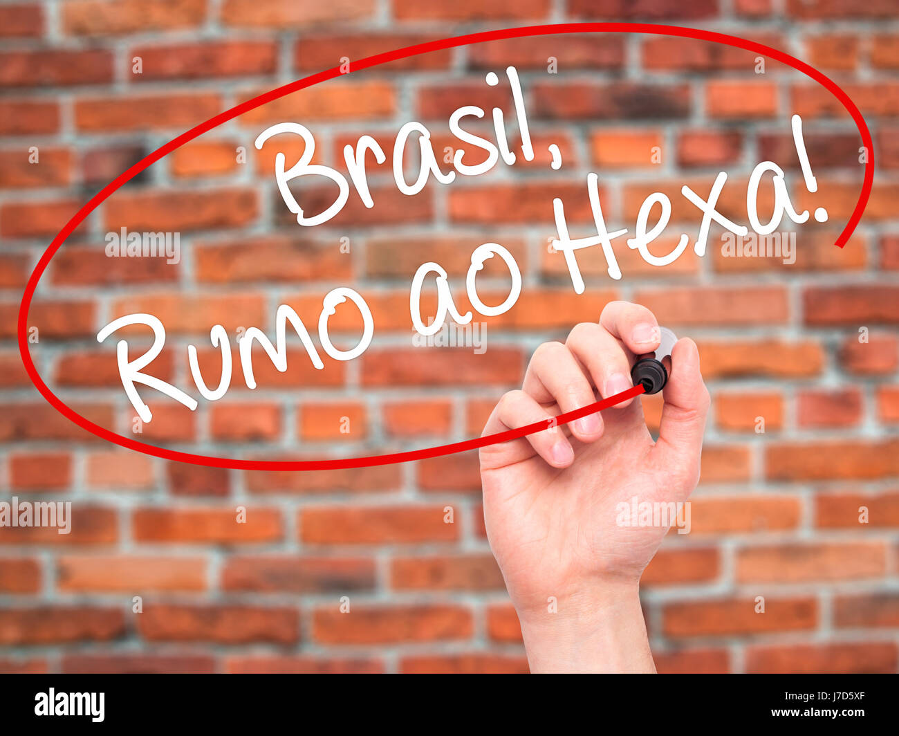 Man Hand writing Brasil, Rumo ao Hexa! with black marker on visual screen. Isolated on background. Business, technology, internet concept. Stock Photo Stock Photo